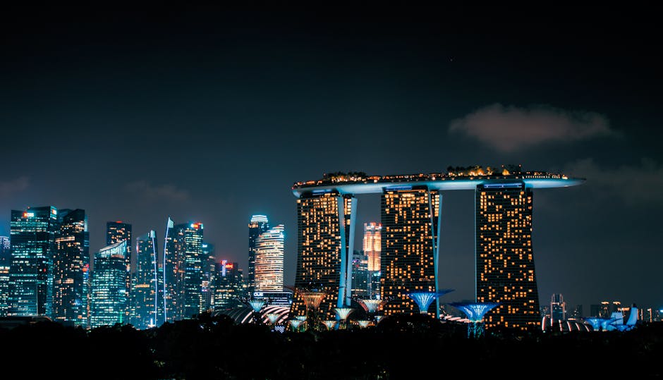 Night view of Singapore's skyline featuring the iconic Marina Bay Sands and illuminated cityscape.