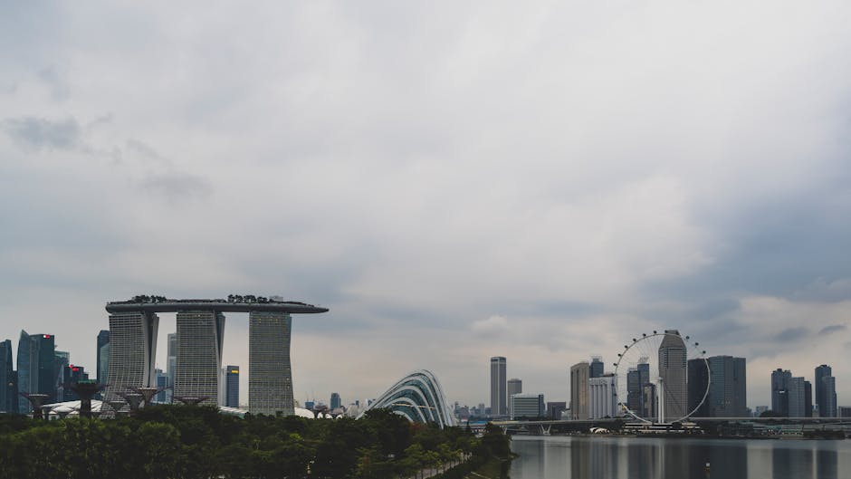 Stunning view of Singapore's skyline featuring Marina Bay Sands and Ferris wheel.